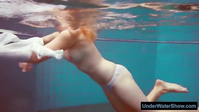 Watch a stunning redhead in a white dress and sexy bikinis now - Pool, beach, and water porn